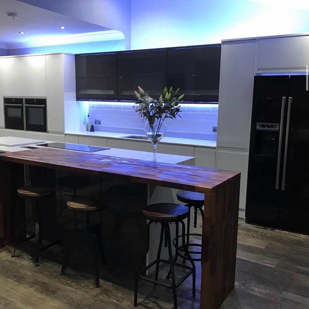 Fitted kitchen with island and feature lighting